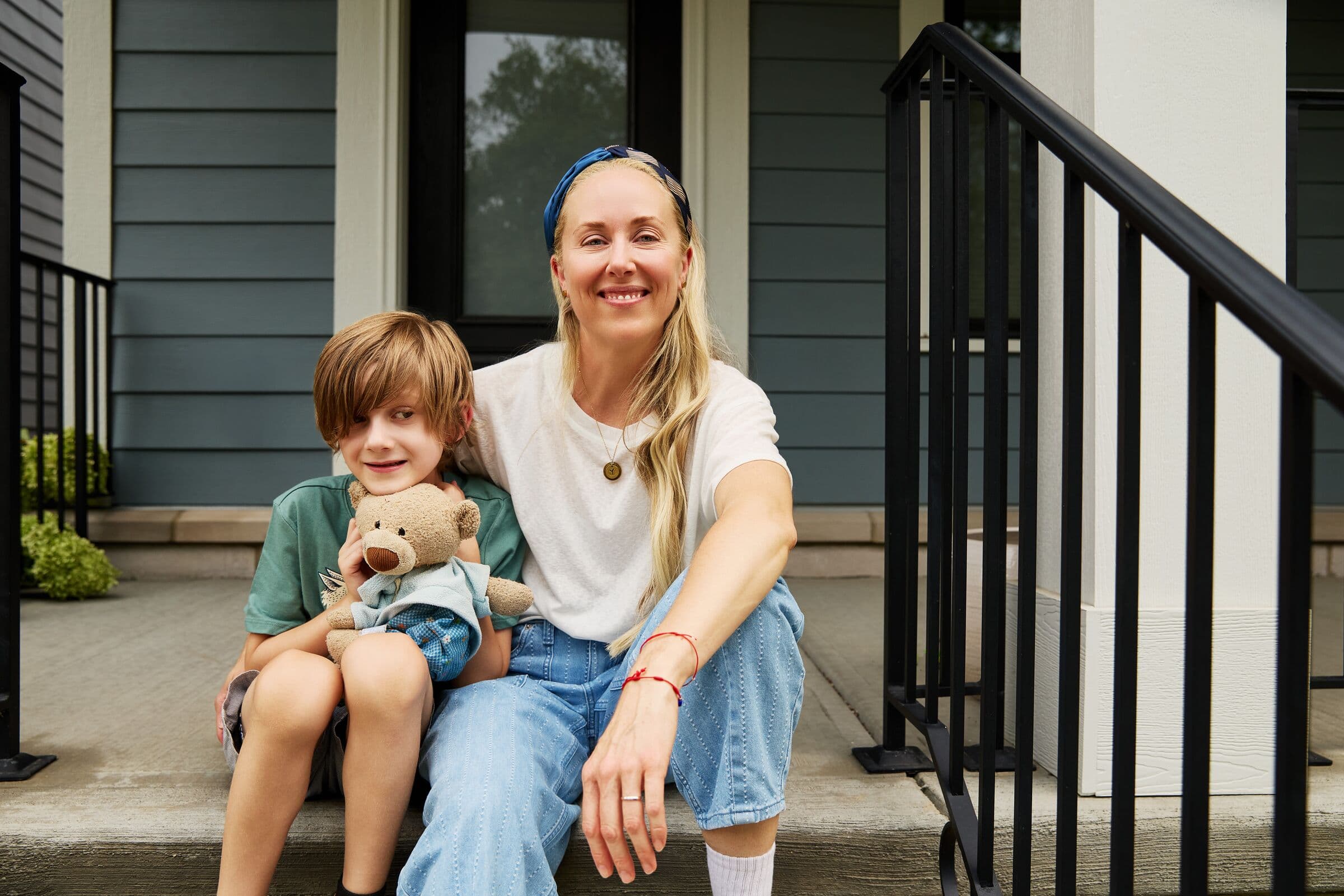 A mother and son relaxing on their front porch