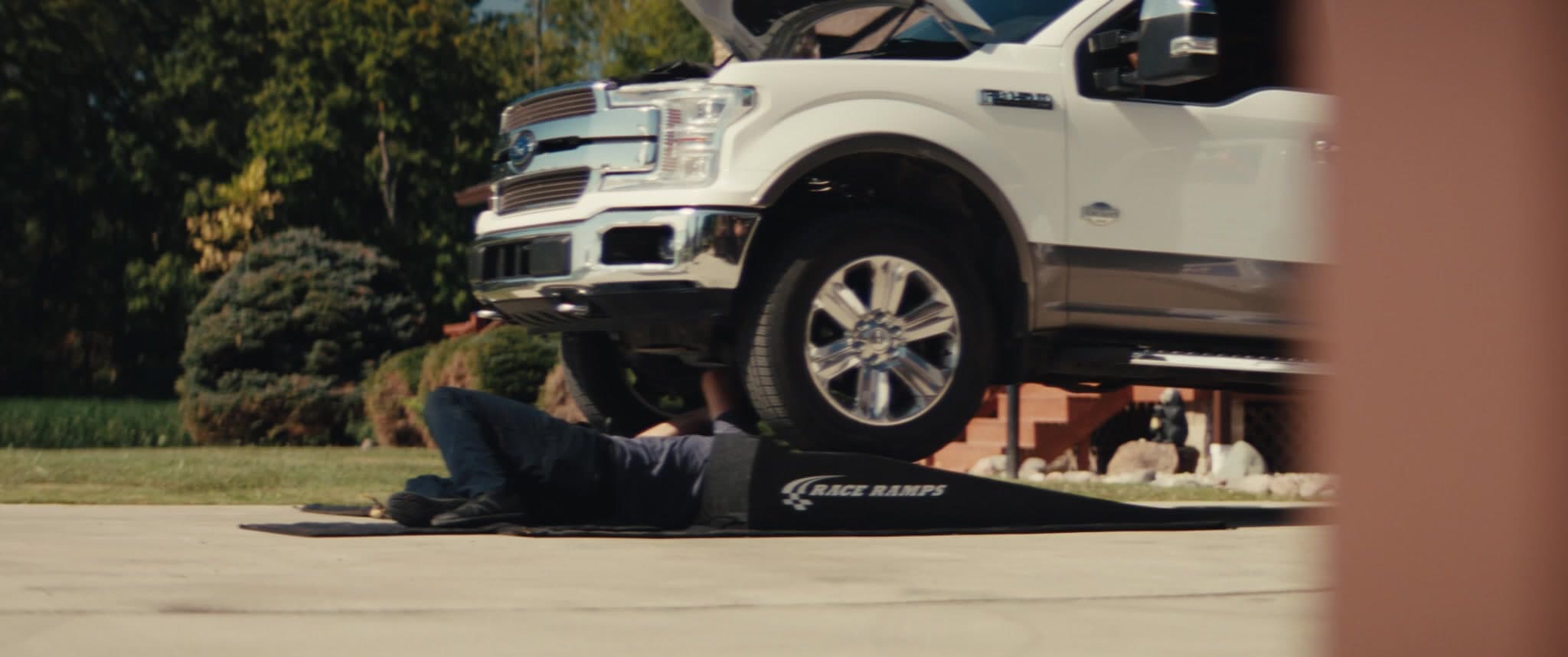 MAXI technician servicing a truck in a customer's driveway
